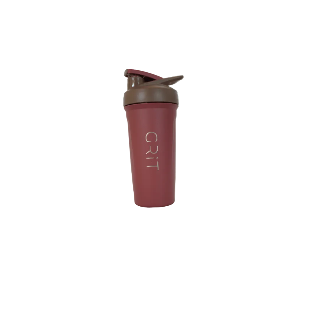 Maroon shaker bottle with brown lid on a white surface